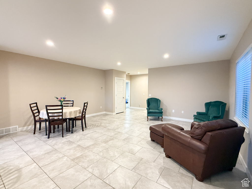 Living area with recessed lighting and light tile patterned floors