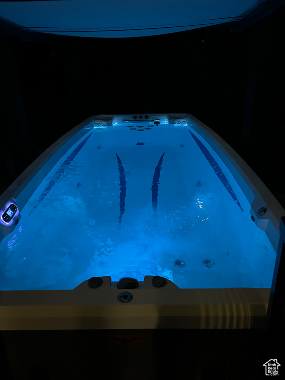 View of swimming pool featuring a hot tub