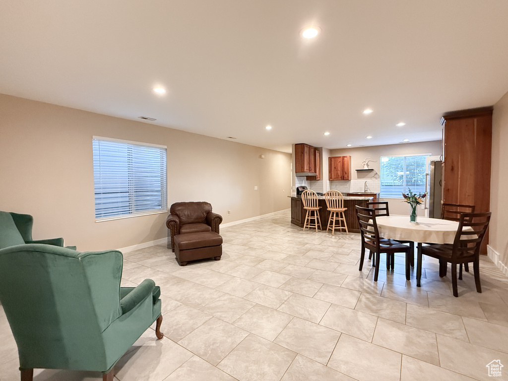 Dining space with recessed lighting and light tile patterned flooring