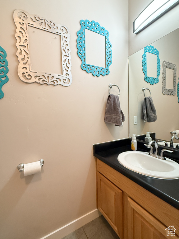 Bathroom with tile patterned floors and vanity