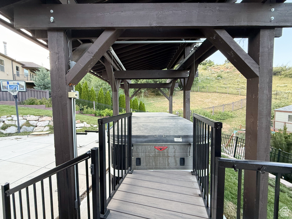 Wooden terrace with a fenced backyard