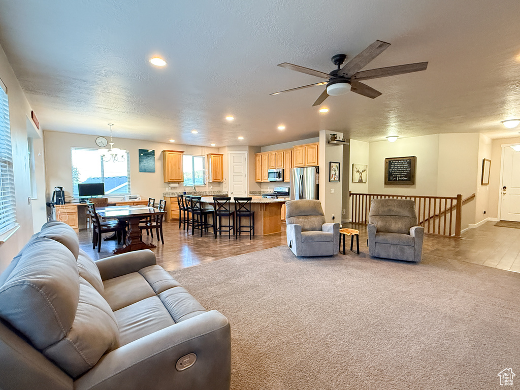 Living room featuring recessed lighting, a ceiling fan, and a textured ceiling