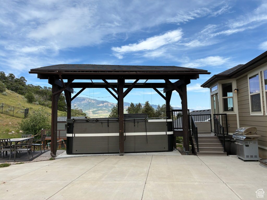 View of patio / terrace with grilling area, a gazebo, and a mountain view