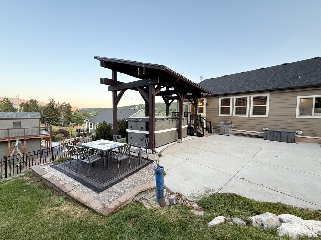 Patio terrace at dusk with a patio and outdoor dining area