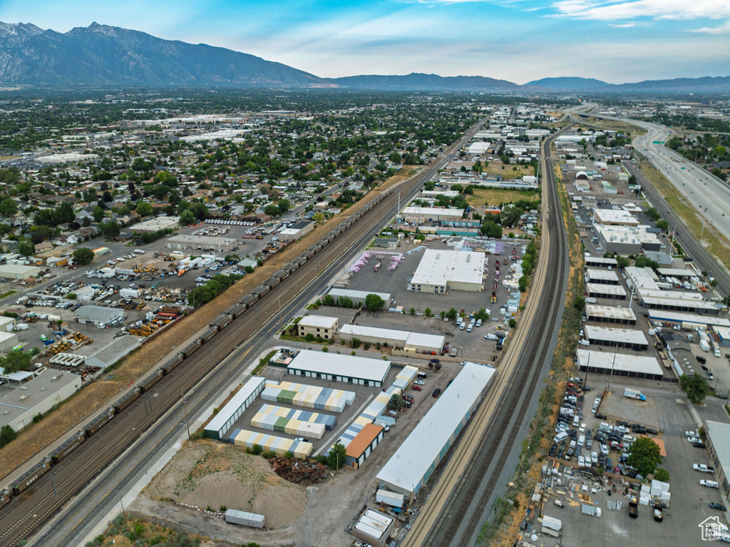 Aerial view of property and surrounding area with a major roadway and mountains