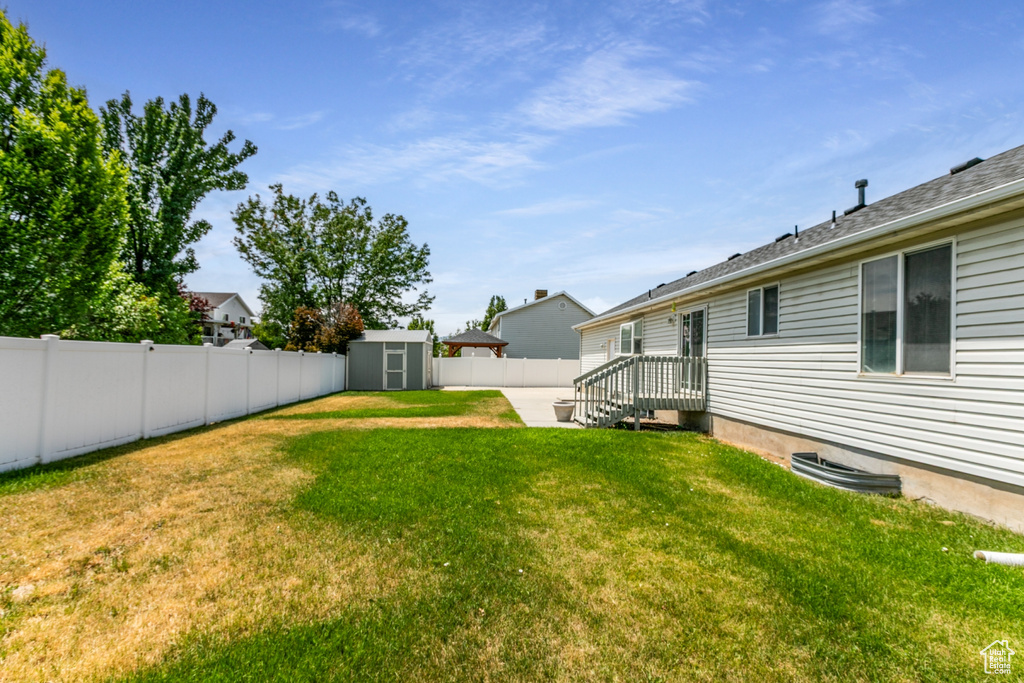Fenced backyard with a storage shed