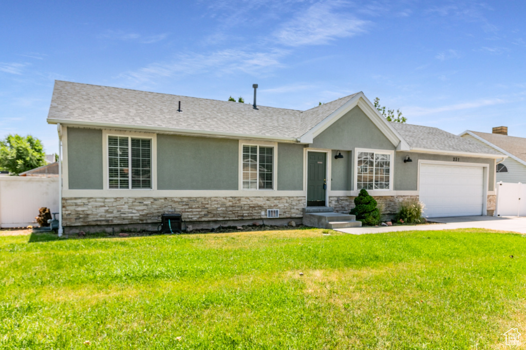Single story home featuring stone siding, a garage, stucco siding, and concrete driveway