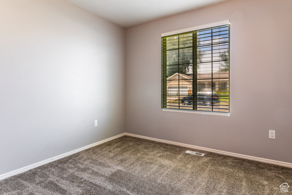 Unfurnished room with carpet floors and baseboards