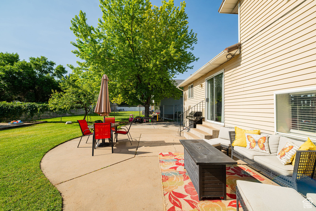 View of patio featuring an outdoor living space and entry steps