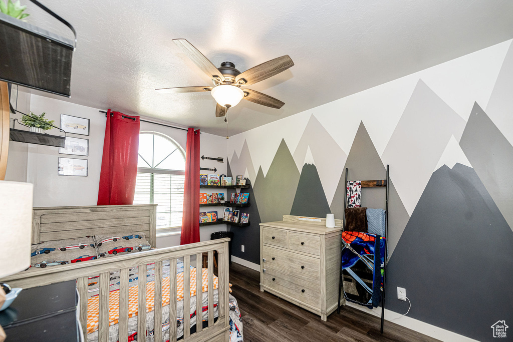 Bedroom featuring dark wood-type flooring and ceiling fan