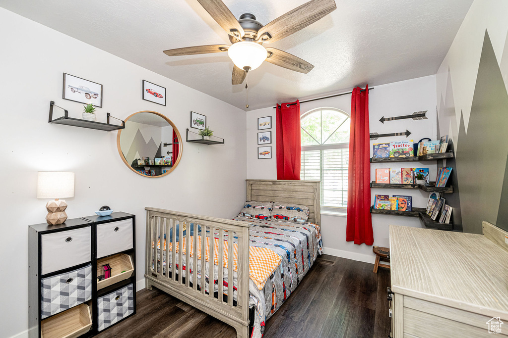 Bedroom featuring wood finished floors and a ceiling fan