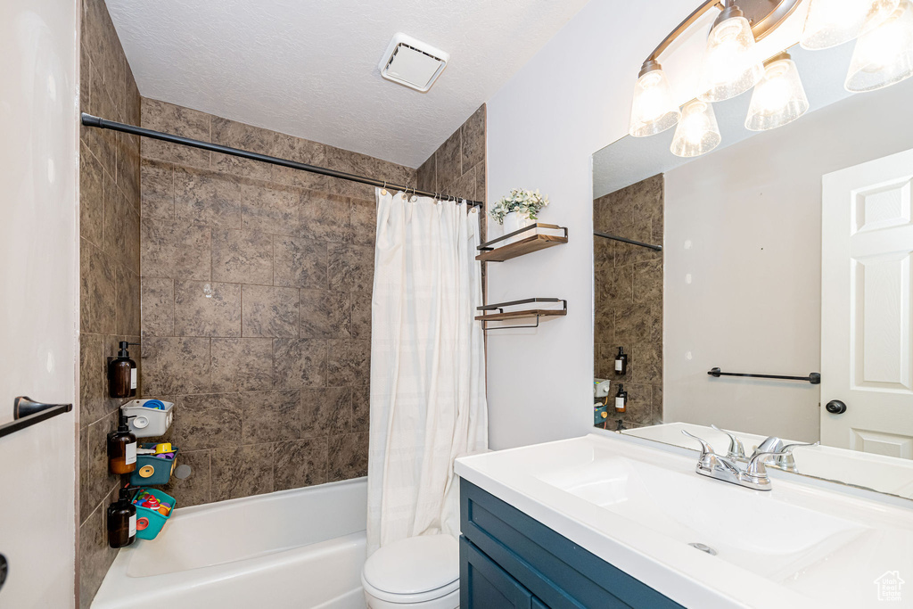 Bathroom featuring vanity and shower / bath combo with shower curtain