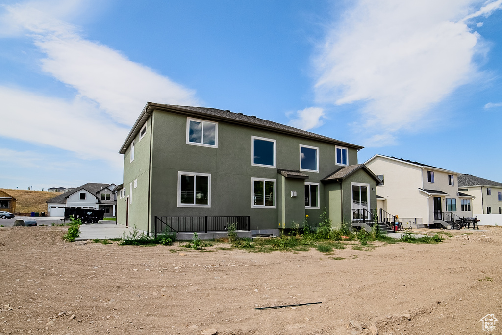 Back of property featuring stucco siding and a residential view