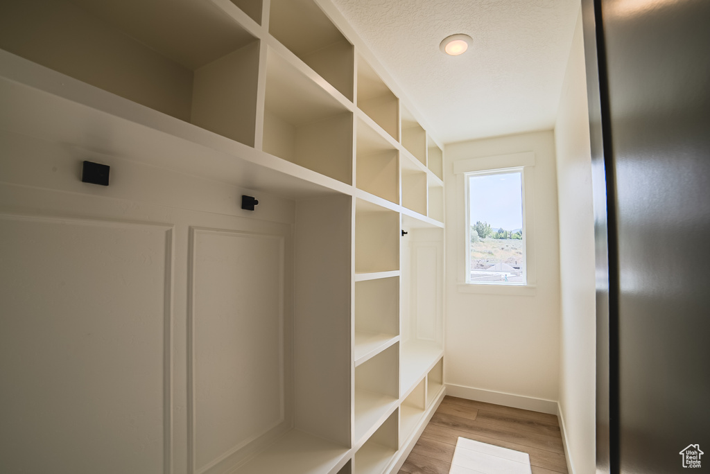 Mudroom featuring wood finished floors and baseboards