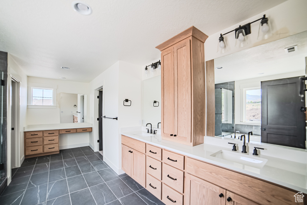 Full bathroom featuring double vanity and tile patterned floors