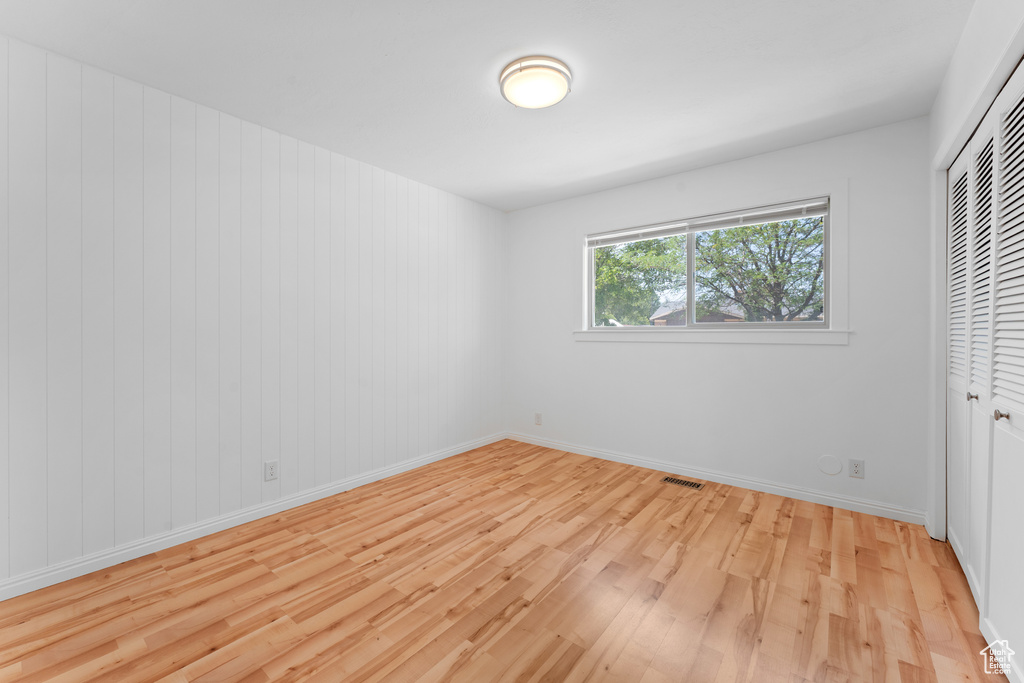 Unfurnished bedroom featuring light wood-type flooring and a closet