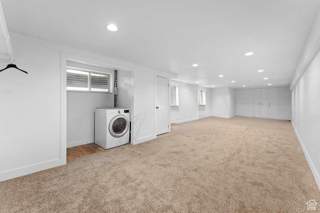 Basement featuring washer / dryer, light colored carpet, and recessed lighting