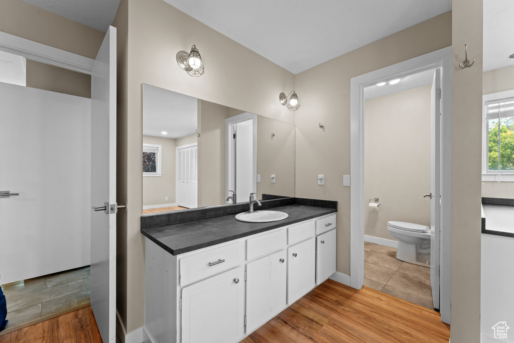 Bathroom featuring vanity and wood finished floors