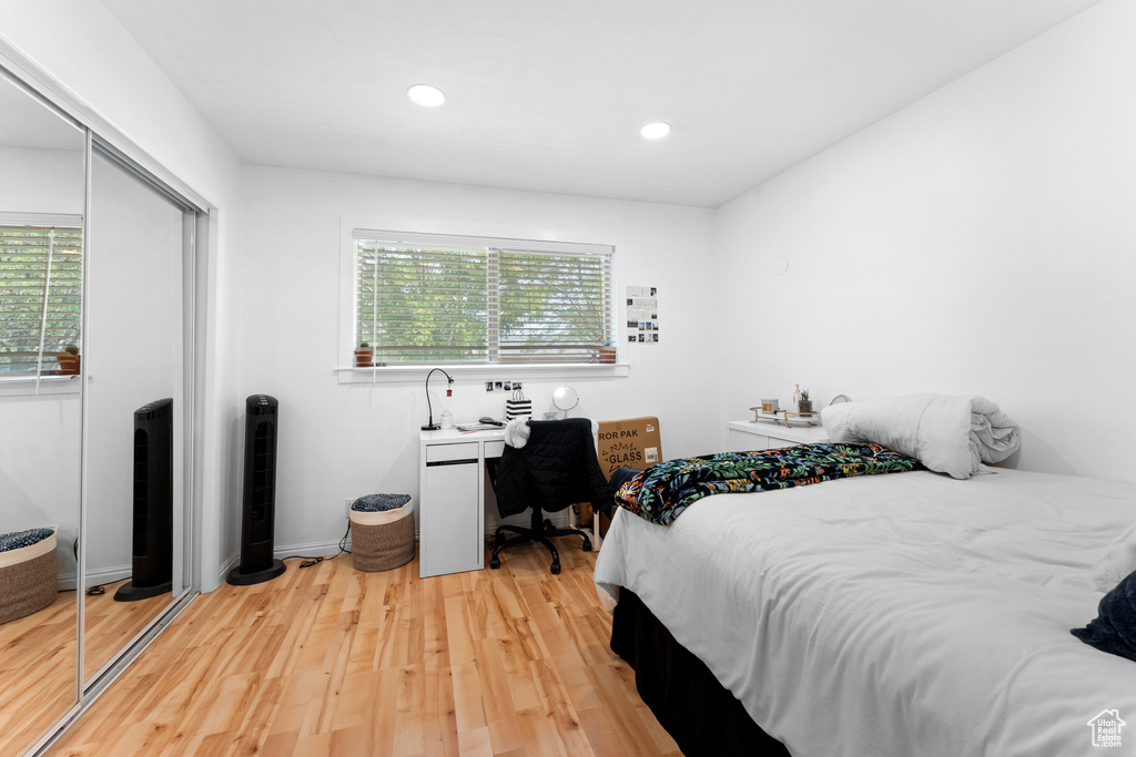 Bedroom featuring a closet, light wood-type flooring, and recessed lighting