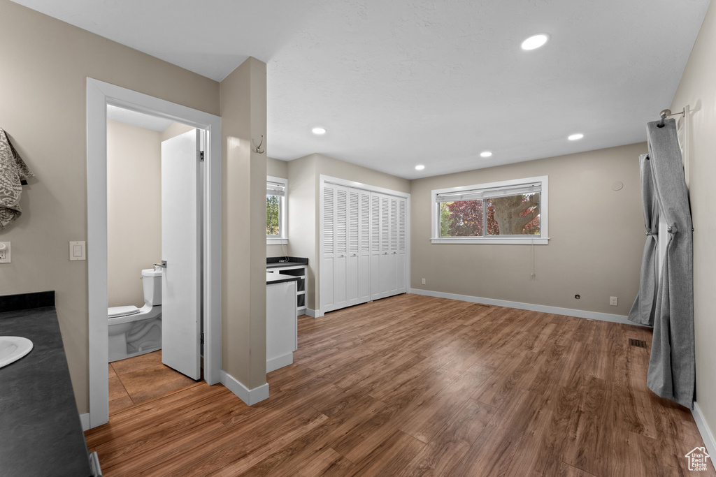 Unfurnished bedroom featuring wood finished floors, recessed lighting, and a closet