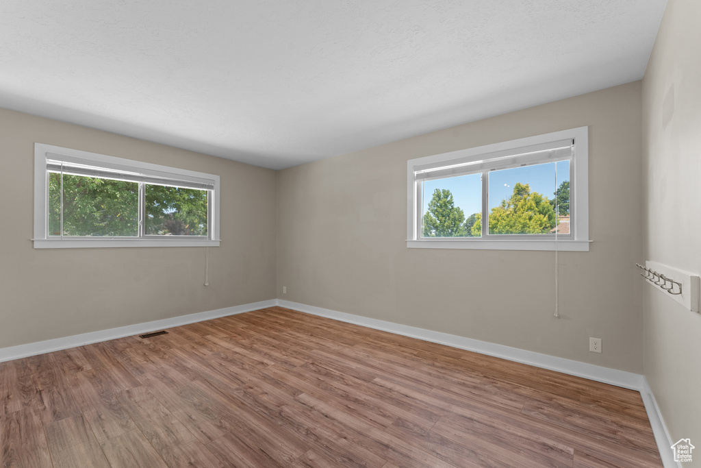 Empty room with wood finished floors and baseboards
