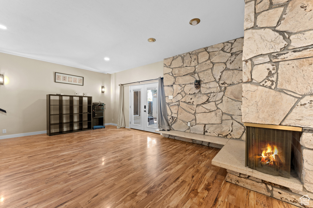 Unfurnished living room featuring wood finished floors and a fireplace