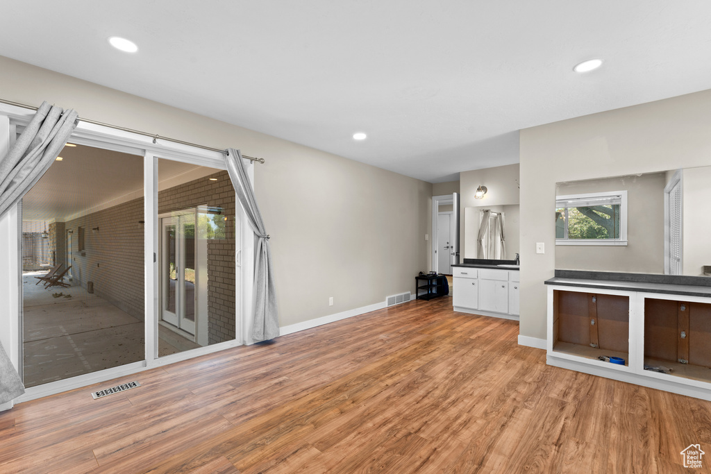 Unfurnished living room with light wood-type flooring and recessed lighting