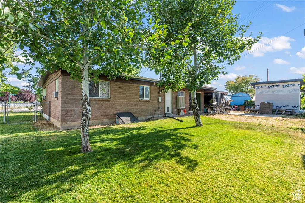 Rear view of property with brick siding