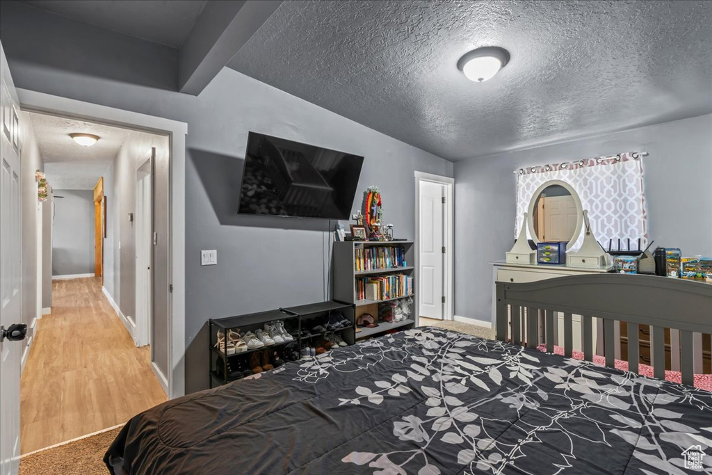 Carpeted bedroom featuring a textured ceiling
