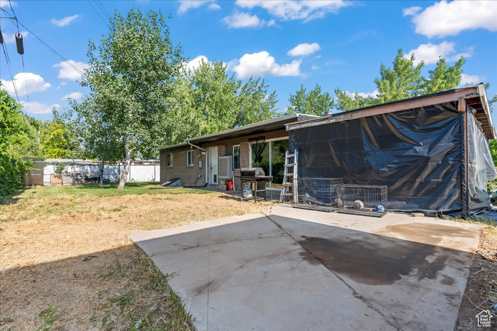Rear view of property featuring a patio area