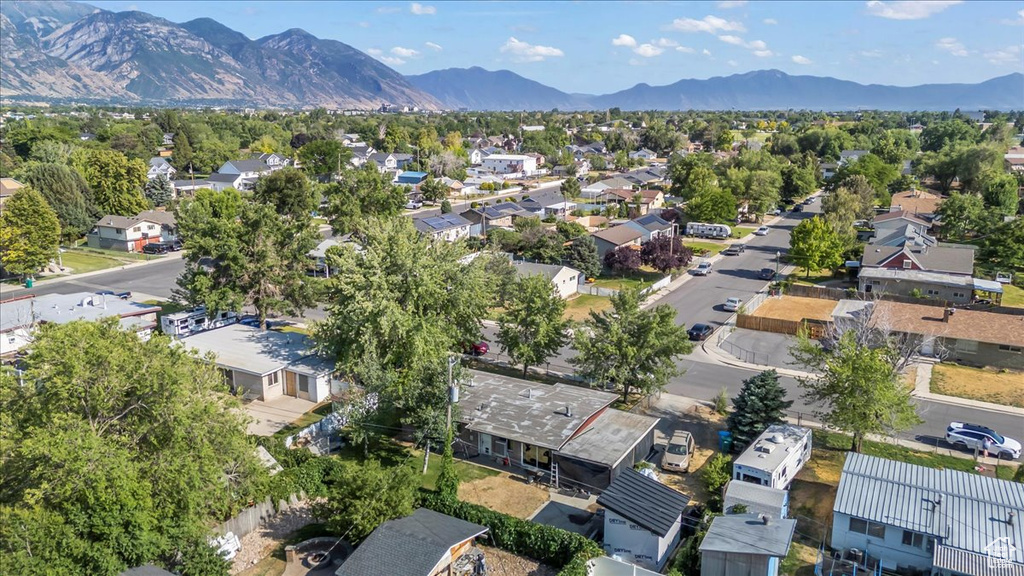 Aerial view of residential area featuring a mountainous background