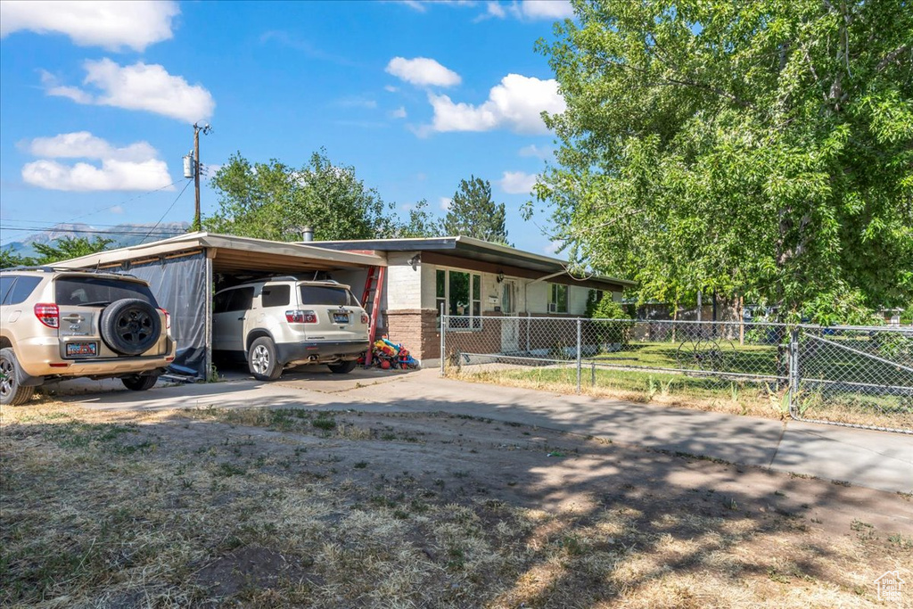 View of front of home with concrete driveway and brick siding
