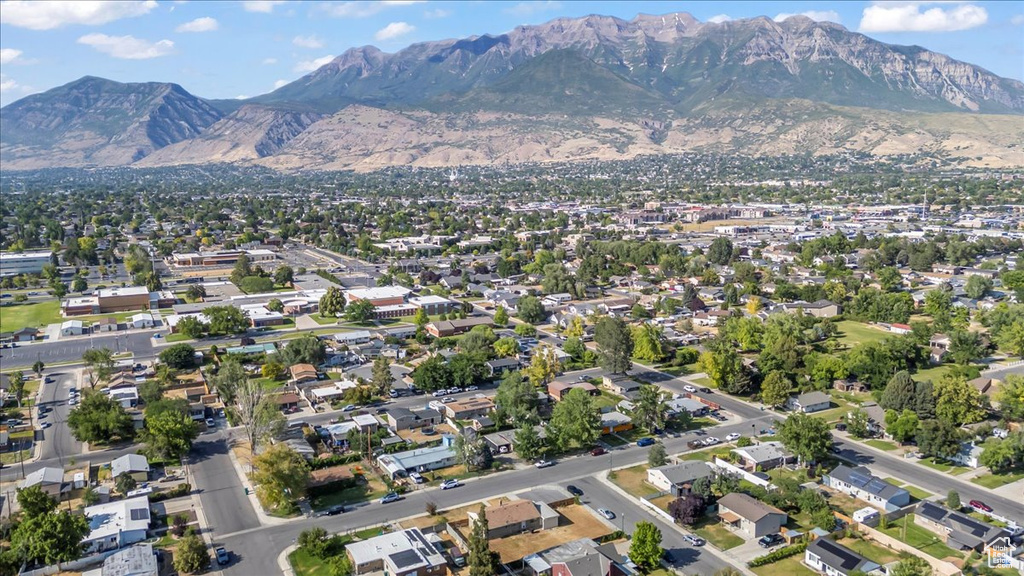 Aerial view of property's location featuring a mountain backdrop and nearby suburban area
