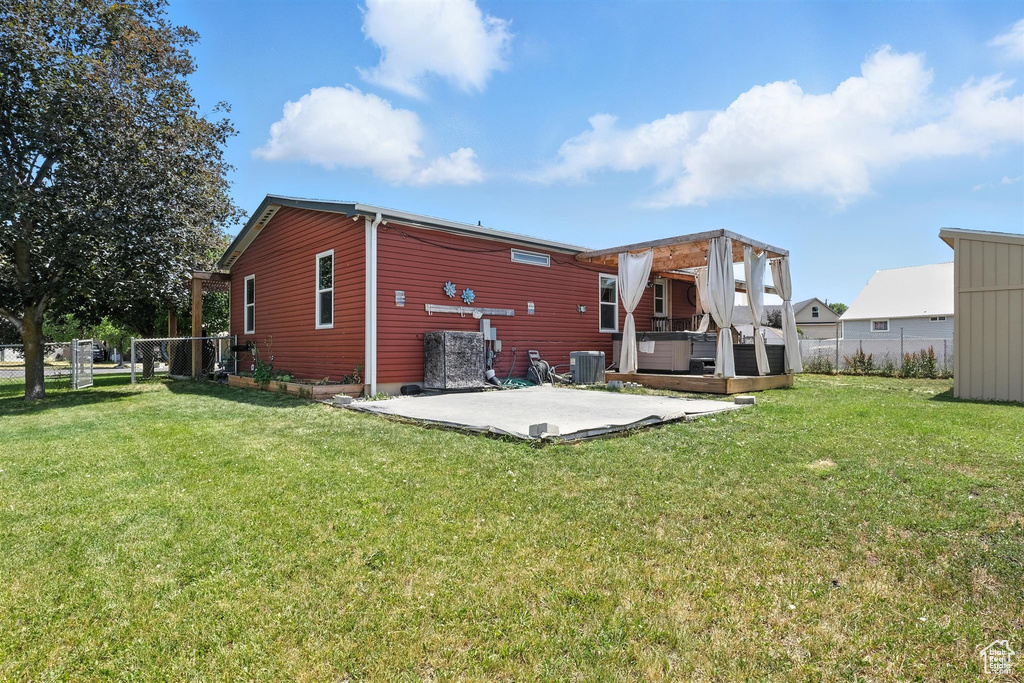 Rear view of house with a patio area and a wooden deck