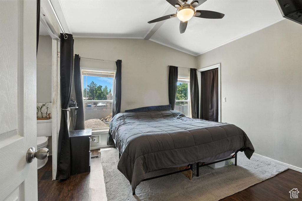 Bedroom with wood finished floors, multiple windows, vaulted ceiling, and ceiling fan