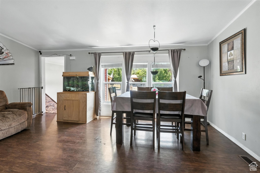 Dining area featuring ornamental molding and wood finished floors