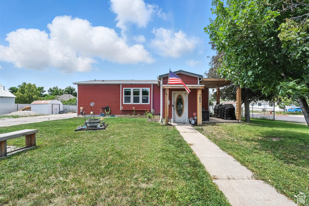View of front of home featuring a storage unit
