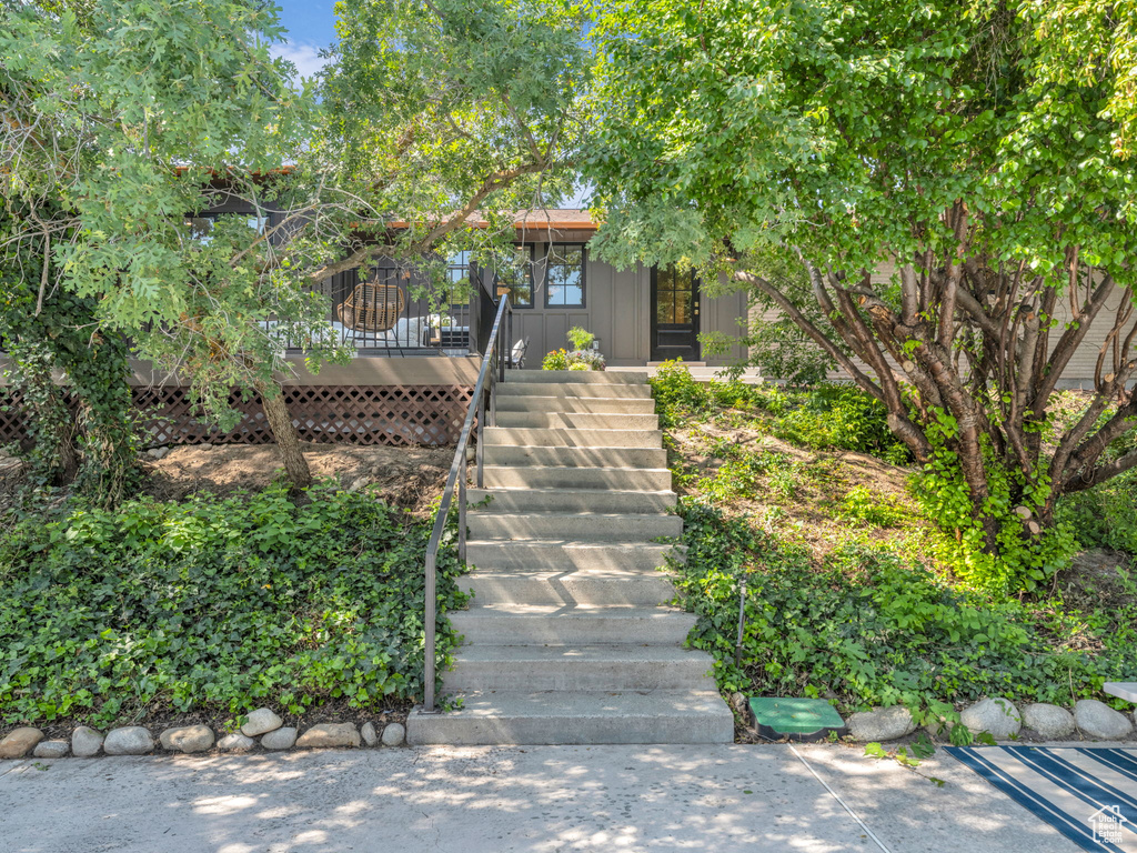 Obstructed view of property with stairway and a deck