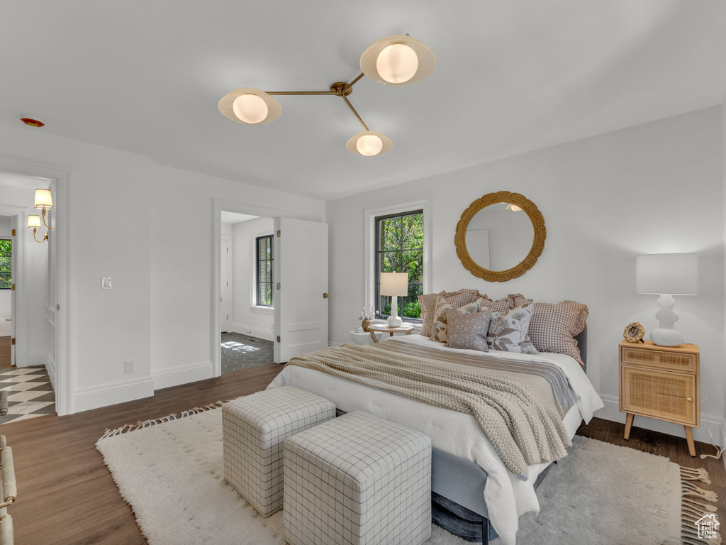 Bedroom featuring wood finished floors and baseboards