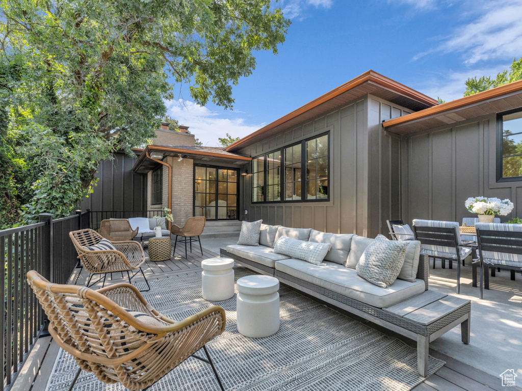 Wooden terrace featuring an outdoor living space and outdoor dining area