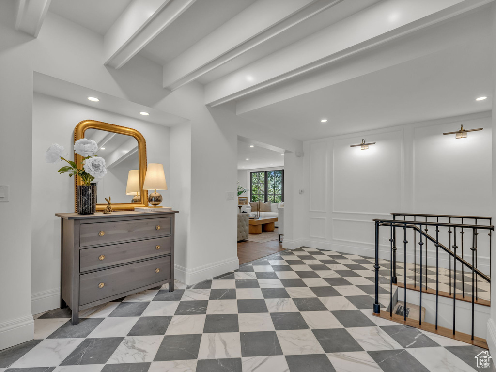 Hallway featuring recessed lighting, stairway, and a decorative wall