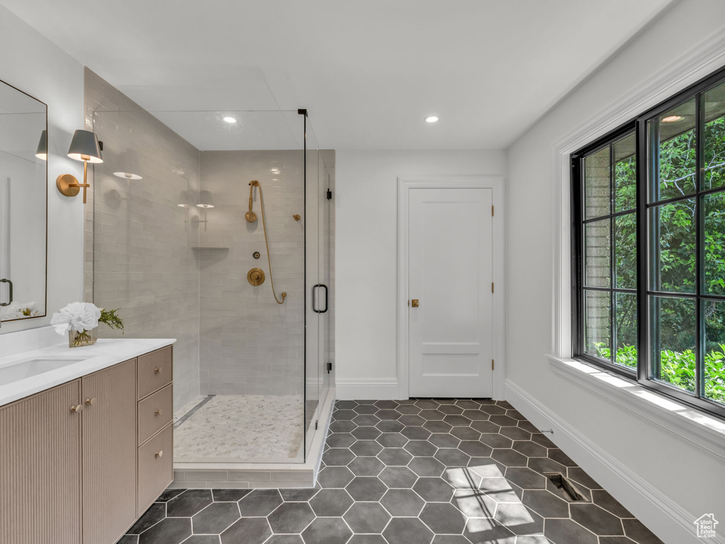 Full bath with vanity, a stall shower, tile patterned flooring, and recessed lighting