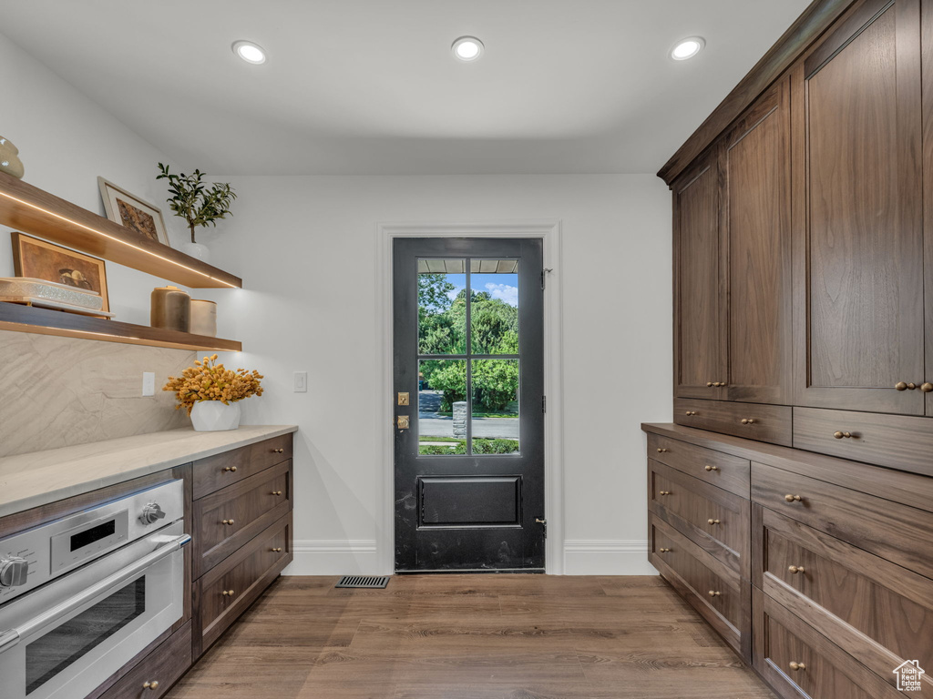 Entryway with light wood-style flooring and recessed lighting