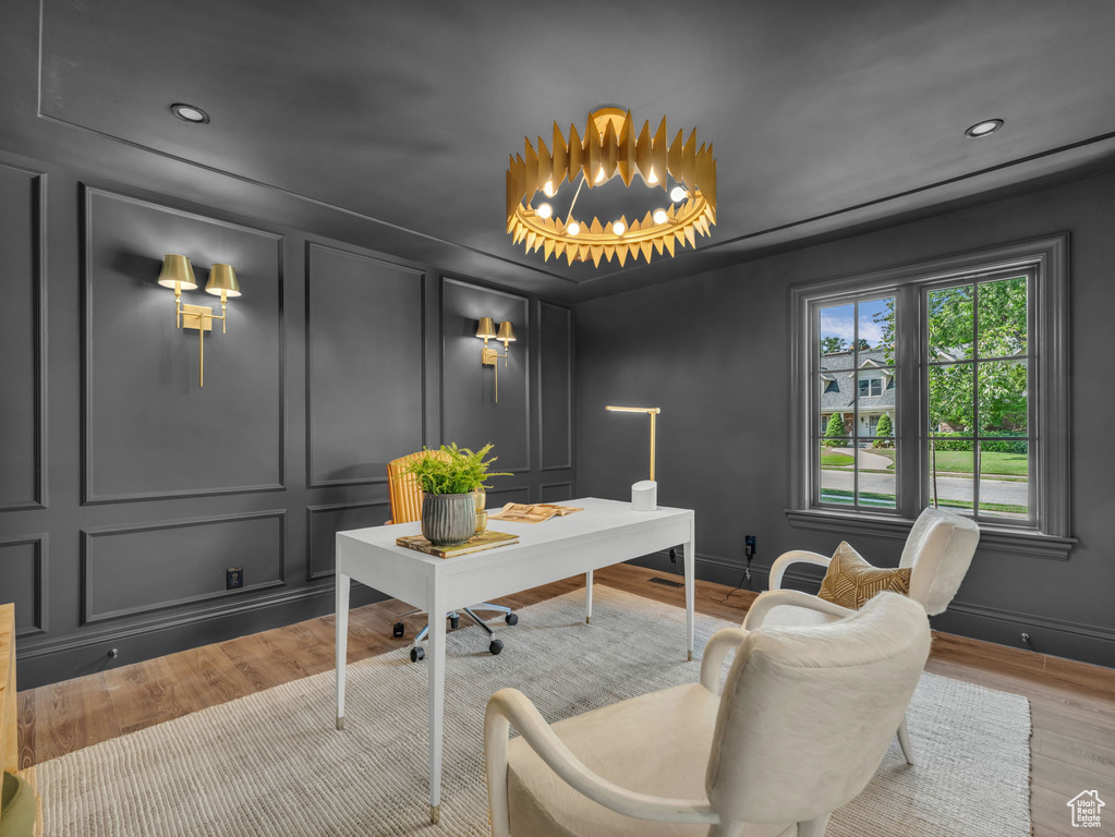 Office area with a decorative wall, wood finished floors, and recessed lighting