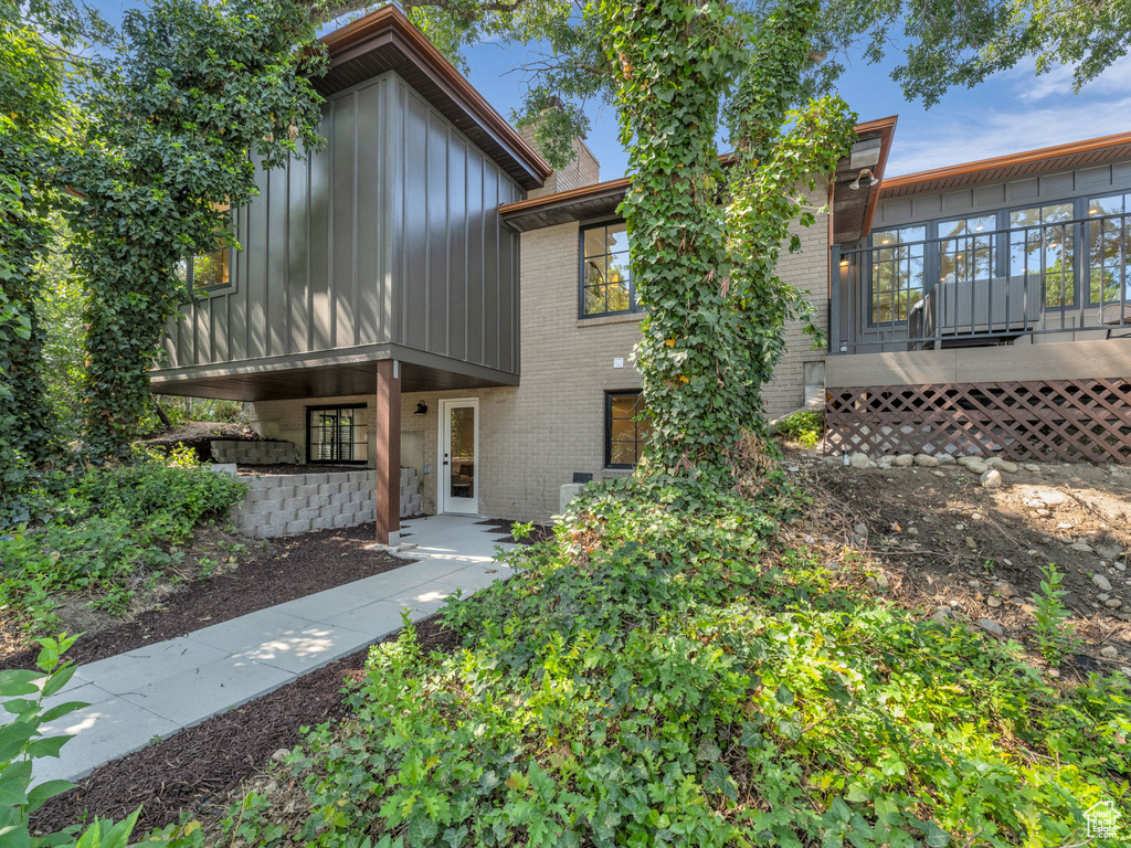View of front of home featuring board and batten siding and brick siding