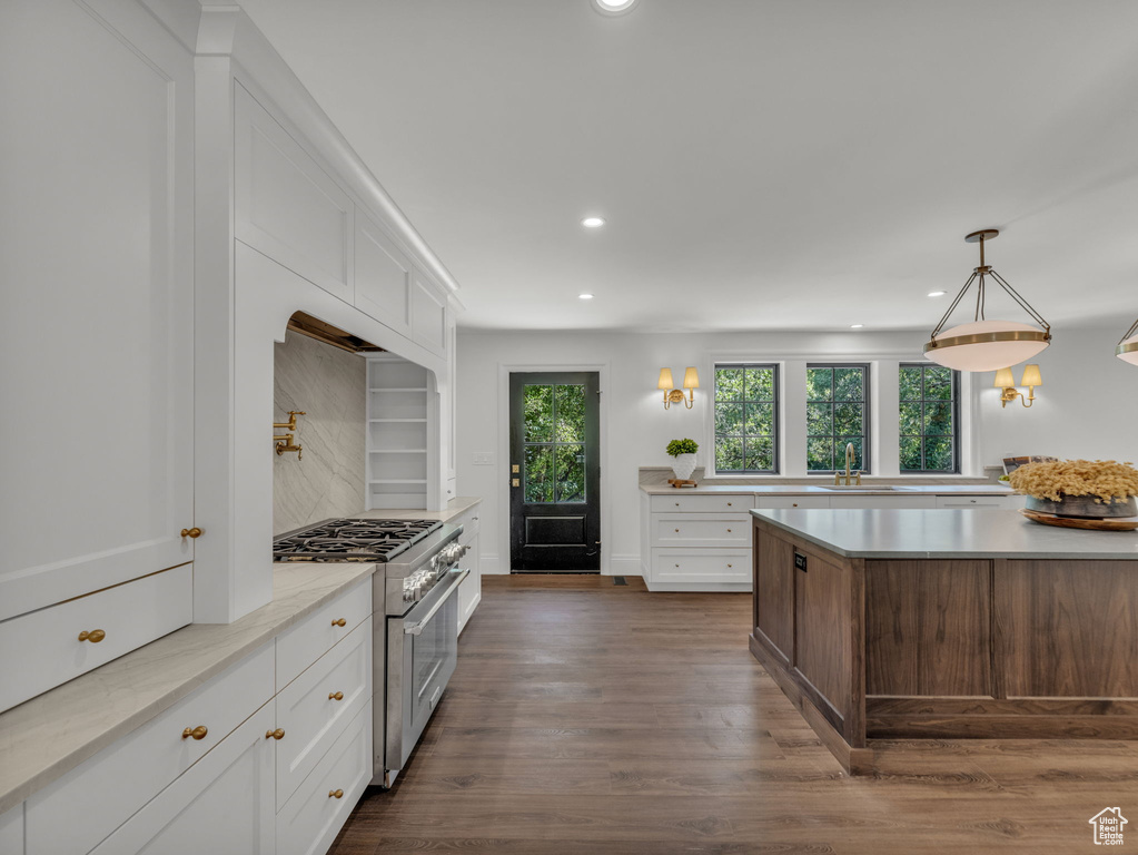 Kitchen featuring stainless steel stove, recessed lighting, light countertops, dark wood-style flooring, and white cabinets
