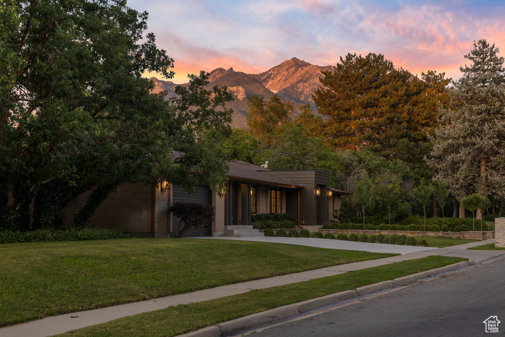 View of front of home with a front lawn and a mountain view