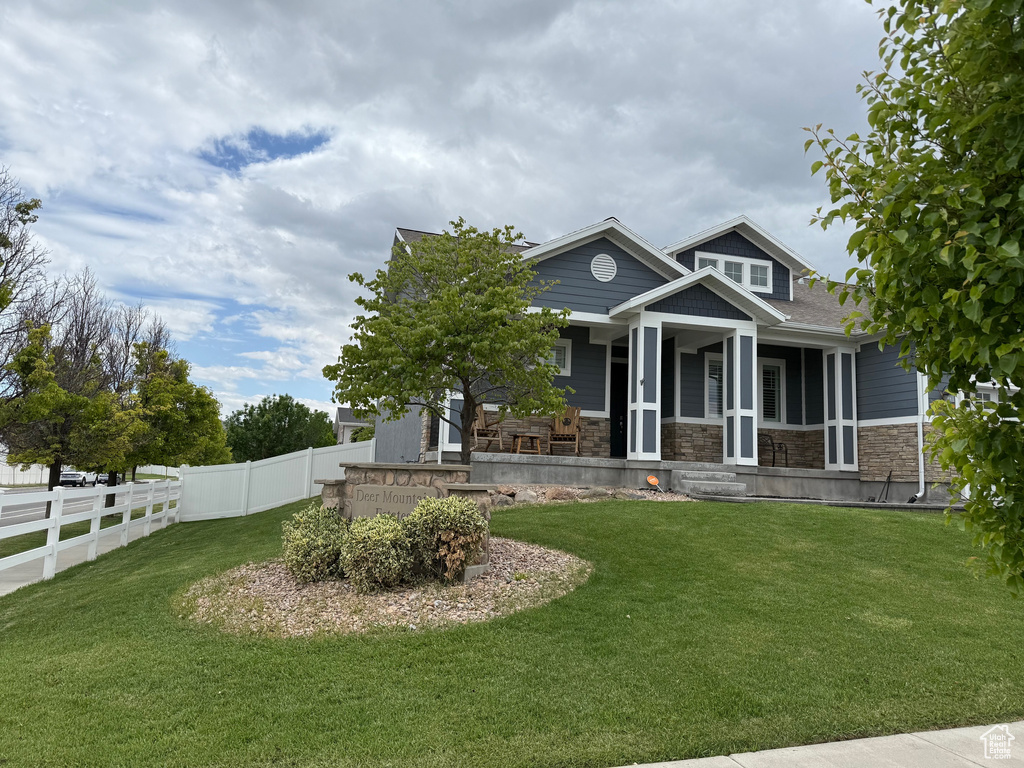 View of front of home featuring a porch and stone siding