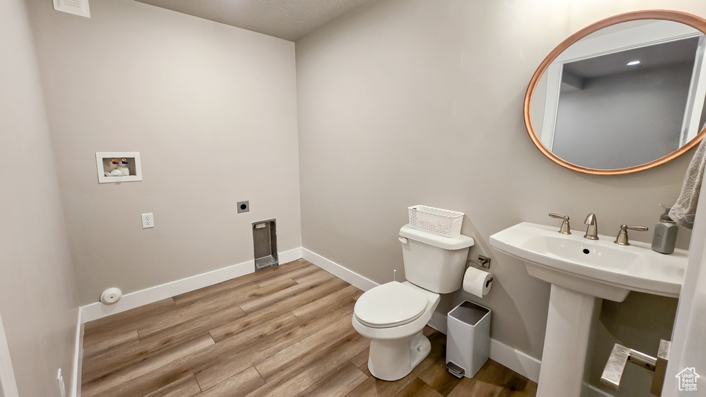 Bathroom featuring toilet and wood finished floors
