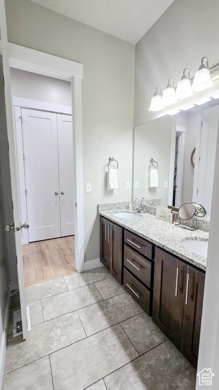 Bathroom featuring double vanity and baseboards